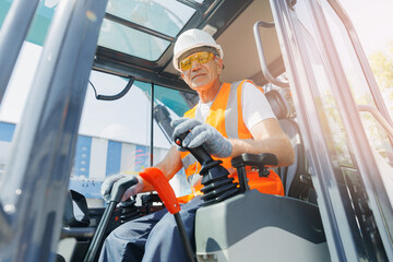 Man driver builder operate crane or excavator at construction site. Industry worker portrait