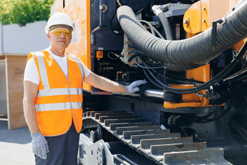 Worker man chek pipe system of hydraulic hose valves in industry machinery