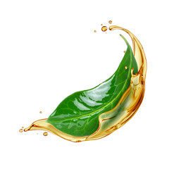Green leaf in splashes of oil close up isolated on a white background
