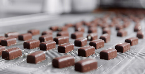 Chocolate sweets candy on industry conveyor. Modern production line of food factory