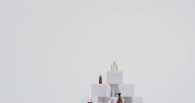 Video of beauty products with white cardboard boxes with copy space over white background