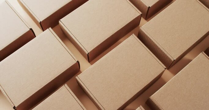 Video of cardboard boxes with copy space over brown background
