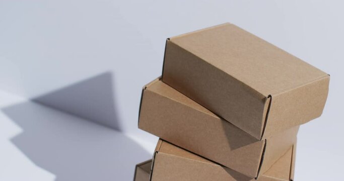 Video of stacked cardboard boxes with copy space over white background