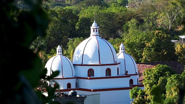 Sunset light giving tridimensional aspect to a church thas has three domes, the second oldest in Latin America