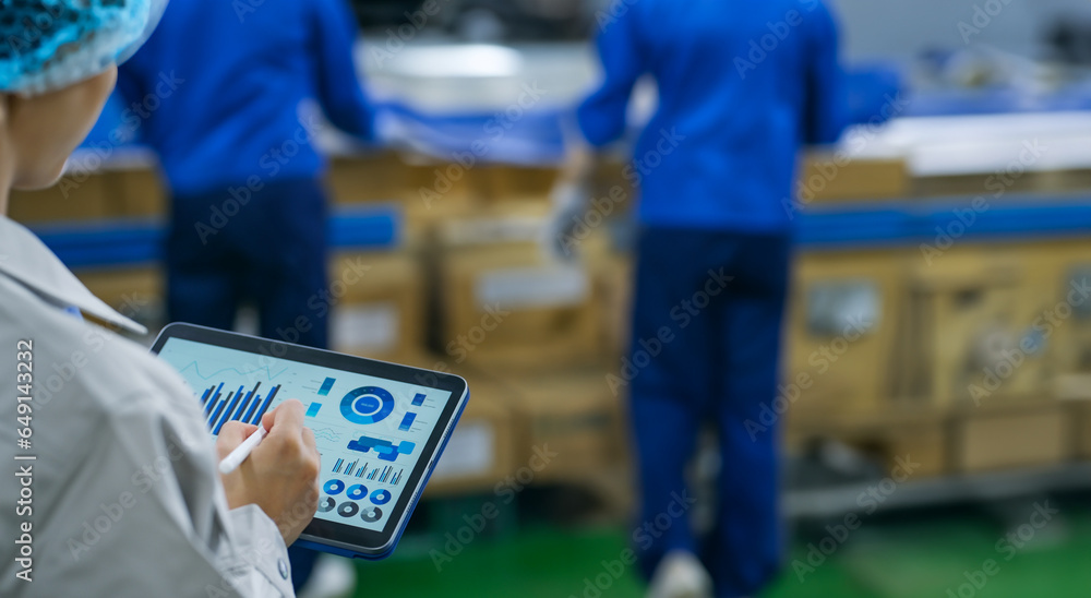 Poster workers using tablets at a distribution center.