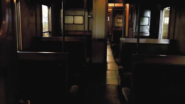 A slow-motion walk into the past: entering a real passenger train's cabin from the 1960s, empty. Lingering shot. 
