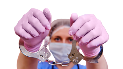 Doctor shows hands in handcuffs on , closeup, isolated on a white background. Hands in medical gloves handcuffed, coronavirus quarantine concept.