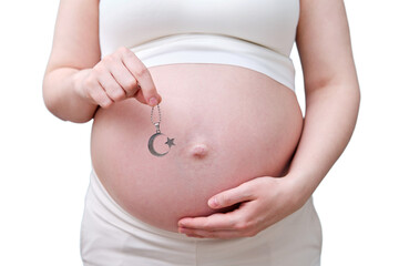 A symbol of the Muslim religion in the hands of a pregnant woman, a studio photo, isolated on a white background