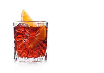 Negroni Cocktail in crystal glass with ice cubes and orange slice on white background with...