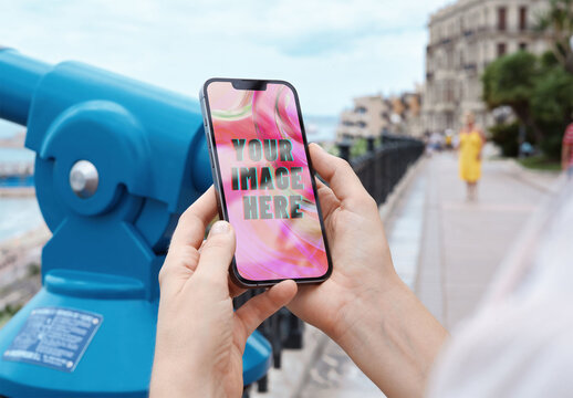 Mockup of person using smartphone with customizable screen by telescope