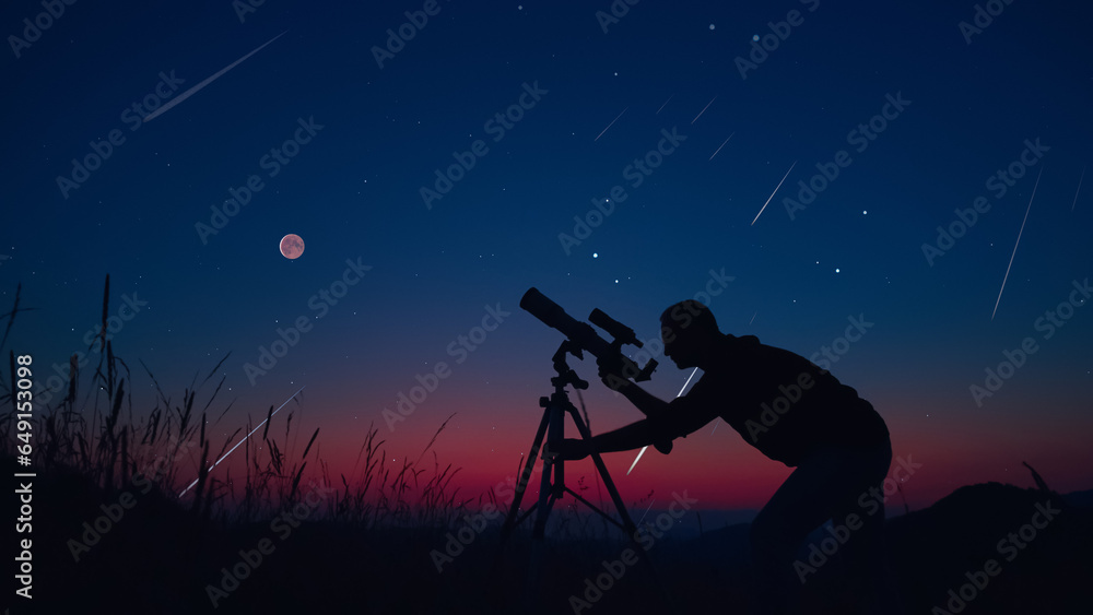 Wall mural astronomer looking at the stars, planets, moon and celestial objects with a telescope.