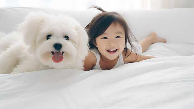 Portrait of beautiful Asian little girl lies in bed with a dog in the morning
