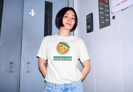 Mockup of Asian woman wearing t-shirt with customizable color and design in elevator, camera flash
