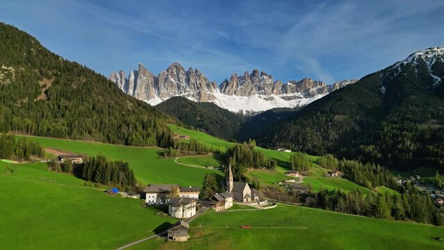 Spring landscape with shurch in Santa Magdalena village, Italian Dolomites Alps, in South Tyrol, Val di Funes, Italy, 4k