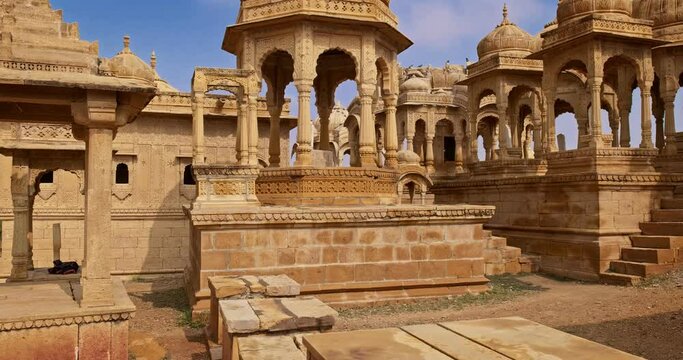 Bada bagh cenotaphs (Hindu tomb mausoleum) made of sandstone in Indian Thar desert. Jaisalmer, Rajasthan, India. Horizontal panning