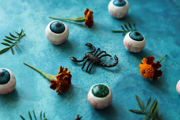 colorful halloween pattern with eyeballs, scorpions and french marigolds