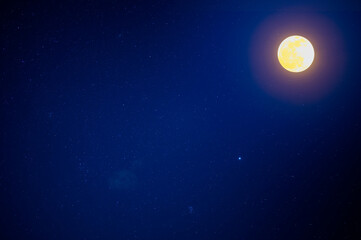 There are moon and stars in the blue sky. Slow exposure photography. Clear night sky in summer, New Taipei City, Taiwan