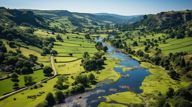 Aerial view of village with river, peak district national park and green fields