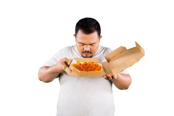 Asian overweight man enjoying aroma holding in hands box with pizza