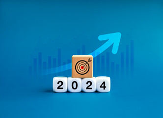 2024 new year goal and success, resolutions, business trends concepts. Target icon on wooden cube...