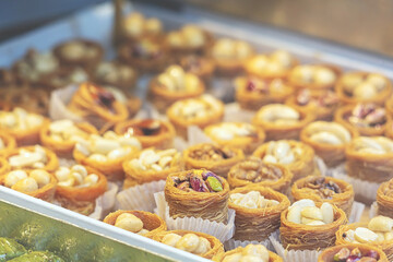 Traditional Dessert Turkish Baklava. Walnut, Pistachio Turkish Style Antep Baklava Presentation. Baklava from Turkish cuisine. Close up, selected focus, swollow deep
