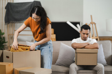 Unhappy young couple sitting apart, having problems in relationship, thinking of breaking up or divorce, upset, family lovers, man and woman avoid talking in relationship problems.