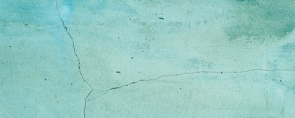 Old weathered blue color painted wall with a crack as a texture, pattern, background