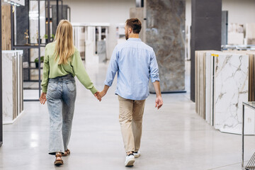 Young couple at the building market choosing tile