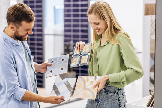 Young couple at the building market choosing tile