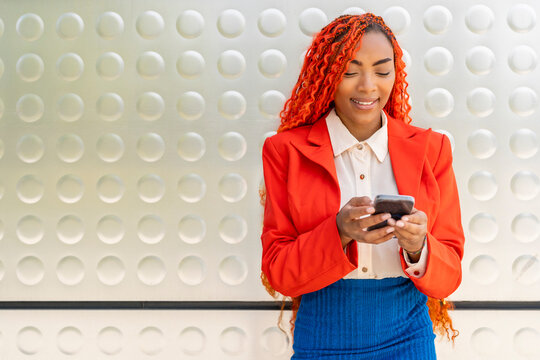 Smiling businesswoman using smart phone in office