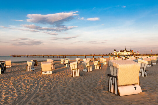 Germany, Mecklenburg-Vorpommern, Ahlbeck, Hooded beach chairs on empty beach at dusk