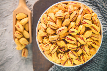Salted in shell pistachios nuts. Top view with close up.
