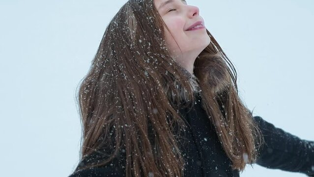 Little cute girl having a fun with a snow in winter cold weather. Winter season joying