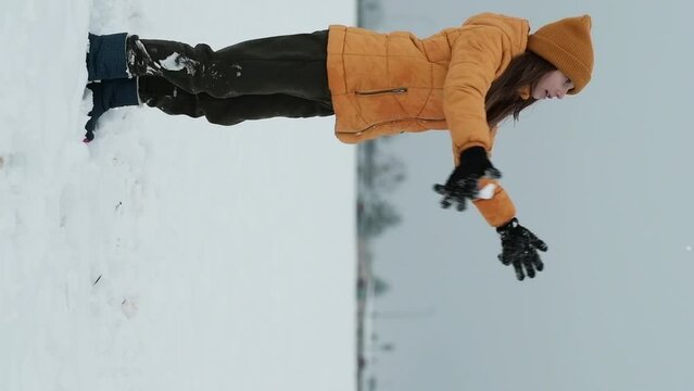 Little cute girl having a fun with a snow in winter cold weather. Winter season joying