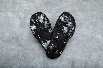Slippers folded in the shape of heart. Sole is stained with white paint. Painter's shoes. Design element for creative advertising cosmetic repairs of apartments, painting works services or pop art