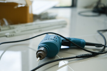 Electric screwdriver and another equipment on floor. Repairing home interior, assembly and improvement concepts