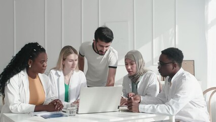 Staff, doctors and nurses with laptop, research and brainstorming for diagnosis. Team, medical professionals and teamwork for cure, discussion and talking for healthcare, analysis and conversation
