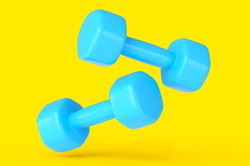 Pair of rubber blue dumbbells isolated on yellow background