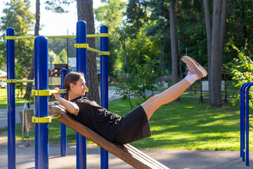 A teenage girl doing abdominal crunches.