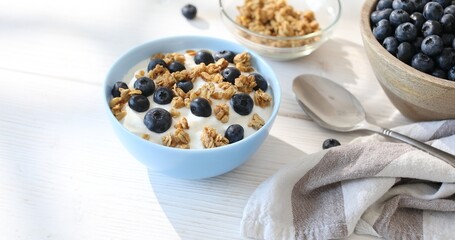 Granola with yogurt and blueberries. Breakfast with muesli and berries. Healthly food. Close-up.