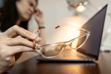 Tired female holding bad spectacles,problem of visual acuity test or inaccurate eye measurement...