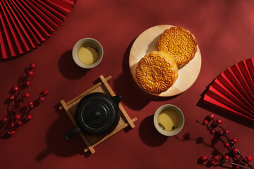 Advertising layout for moon cake products on a red background. Mooncakes on wooden tray decorated...