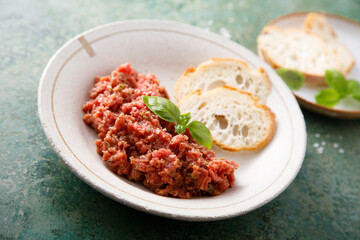 Traditional steak tartare with baguette bread