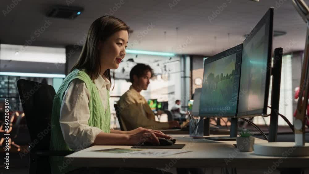 Poster Female Asian Game Developer Using Desktop Computer, Designing Unique World And Characters In 3D modelling Software For Survival Video Game. Creative Woman Working In Diverse Game Design Studio Office.