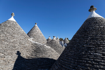 Fototapeta na wymiar Roofs of Trulli of Alberobello, the typical limestone houses in the province of Bari, Puglia, Italy