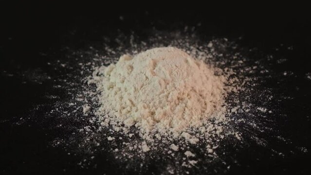 Pile of Guar gum powder or guaran. Food additive E412, close-up. Thickening agent. Guar Gum widely used in food industry and cosmetics. Video, Rotating, slow motion.