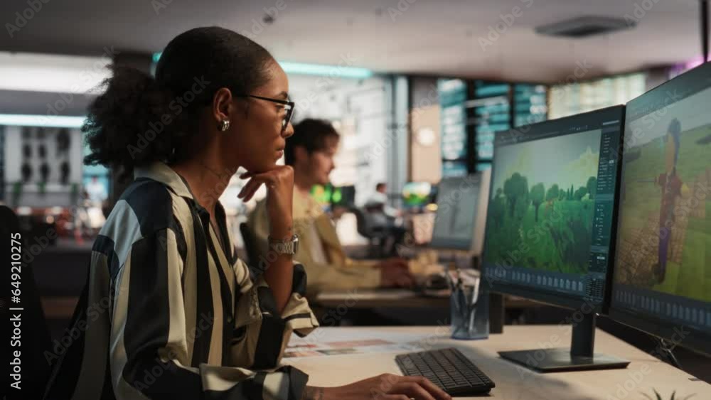 Aufkleber Female Black Game Designer Using Desktop Computer, Designing Unique World And Characters In 3D modelling Software For RPG Video Game. African American Woman Working In Game Development Studio Office.