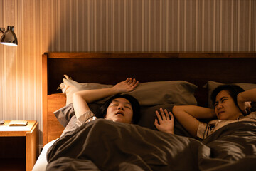 Asian teenage girl snoring in bed having chronic nasal congestion,symptom of obstructive sleep...