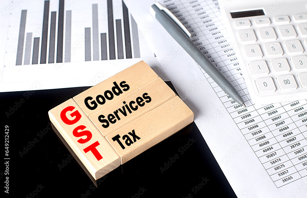 Poster word gst made with wood building blocks with chart and calculator