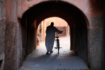 Man with bike in Marrakesh medina (old city), Morocco.